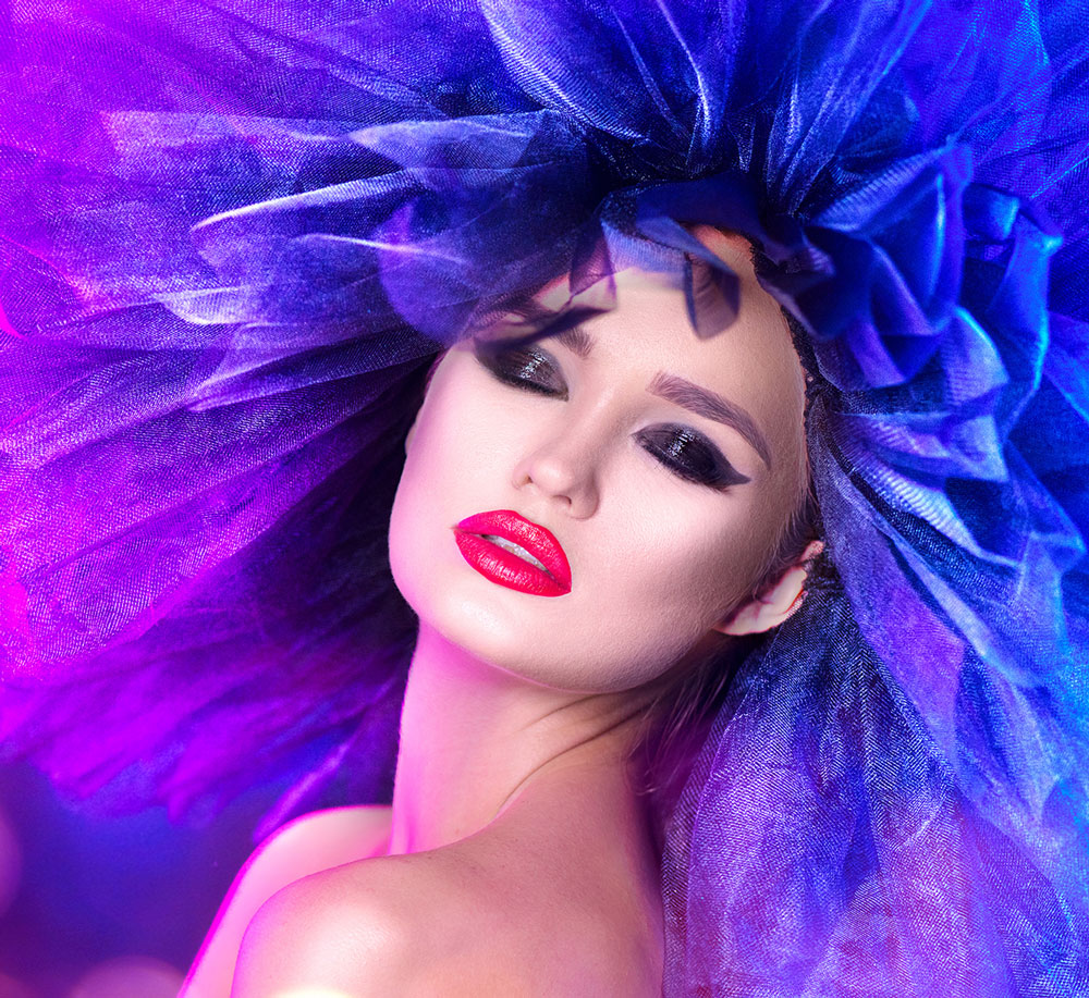 Glamourous woman dress up in vibrant hat.