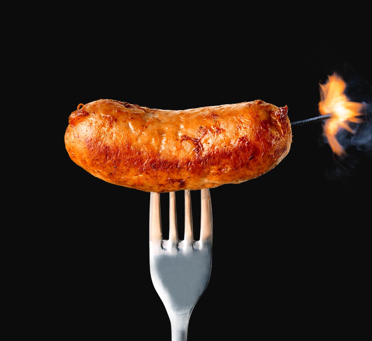 Nice cooked sausage on a fork with a fuse like a stick of dynamite!