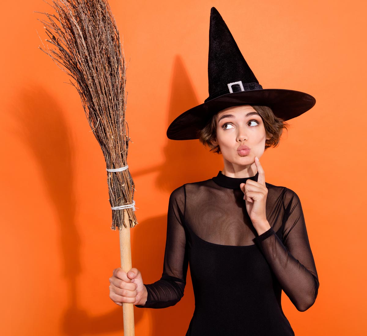 comical Witch with broomstick looking puzzled