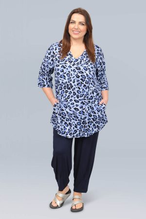 The model in this photo is wearing a mid length v neck tunic in a funky blue leopard print from Angel Circle at Bakou London