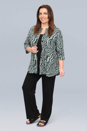 The model in this photo is wearing a stylish short shirt in a funky squiggle print by Danish plus size experts Angel Circle at Bakou London