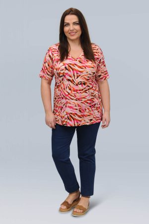 The model in this photo is wearing a bright and cheerful pink patterned t-shirt by plus size experts KJ Brand available from Bakou London