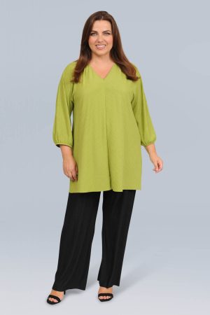 The model in this photo is wearing a luxurious v neck plisse tunic in gorgeous peppermint in plus sizes at Bakou