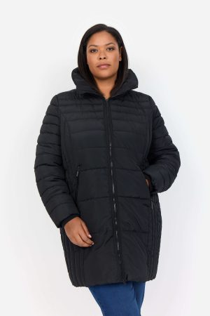 The model in this photo is wearing a very flattering Wasabi Concept quilted jacket made from recycled plastic from plus size experts Bakou London