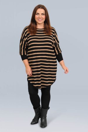 The model in this photo is wearing a black and desert brown stripe Shanti jumper by Wasabi Concept at Bakou London for plus size ladies