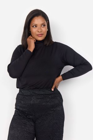 The model in this photo is wearing a silky soft Wasabi Concept Stella 30 polo neck basic top with a luxurious feel for curvy girls at Bakou London