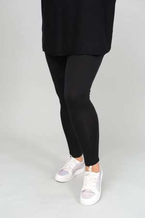 The model in this photo is wearing Wasabi Stella 11 black jersey leggings for larger sizes